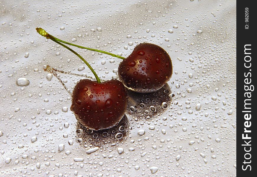 Pare of black cherries with water drops. Pare of black cherries with water drops