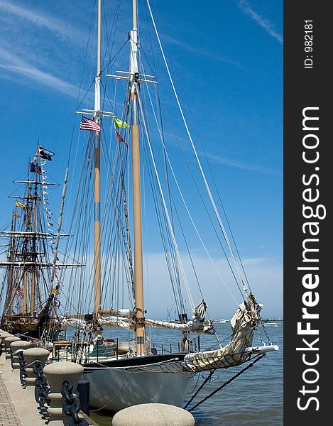 2 tall ships at dock.