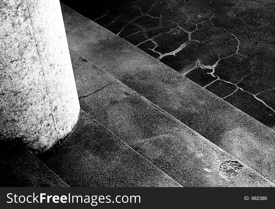 Close shot - white pillar at left, four steps. High contrast, moody. Close shot - white pillar at left, four steps. High contrast, moody.