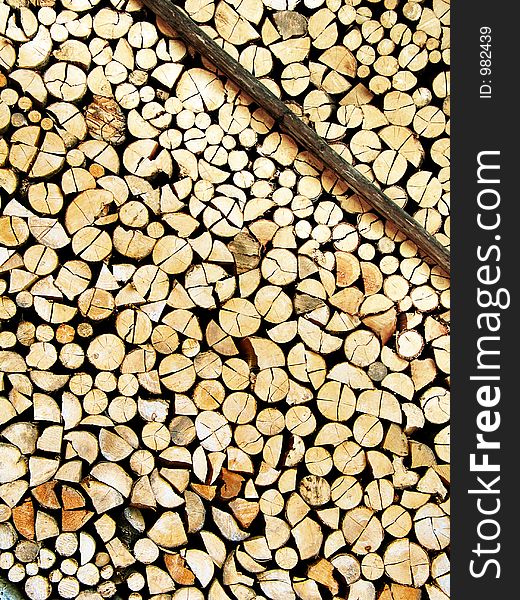 A nicely stored stock of cut wood supported by a narrow bar - resource for a long winter. Great for backgrounds and wallpapers. A nicely stored stock of cut wood supported by a narrow bar - resource for a long winter. Great for backgrounds and wallpapers.