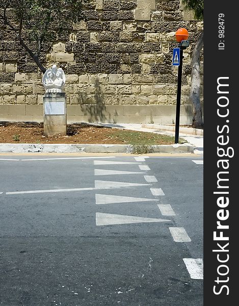 Pedestrian crossing with road marking and sculpture