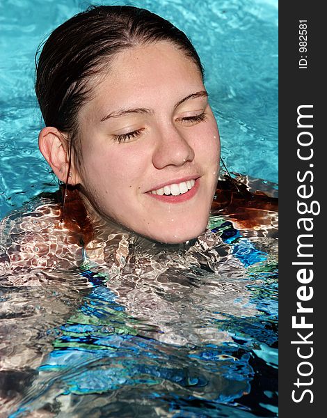 Happy girl swimming in a pool. Happy girl swimming in a pool