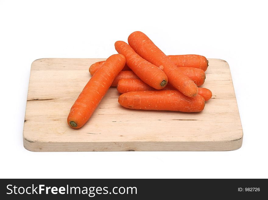 Carrots arranged on a wooden chopping board