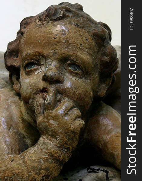 Bronze cherub shushing. Bronze cherub shushing