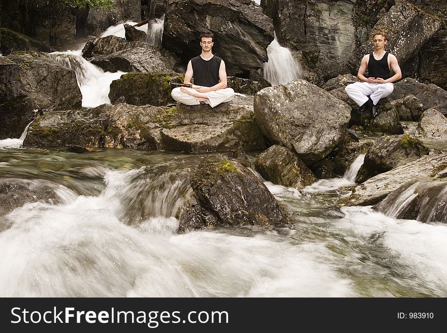 Two man meditating outdoor after practicing fencing with katanas. Two man meditating outdoor after practicing fencing with katanas