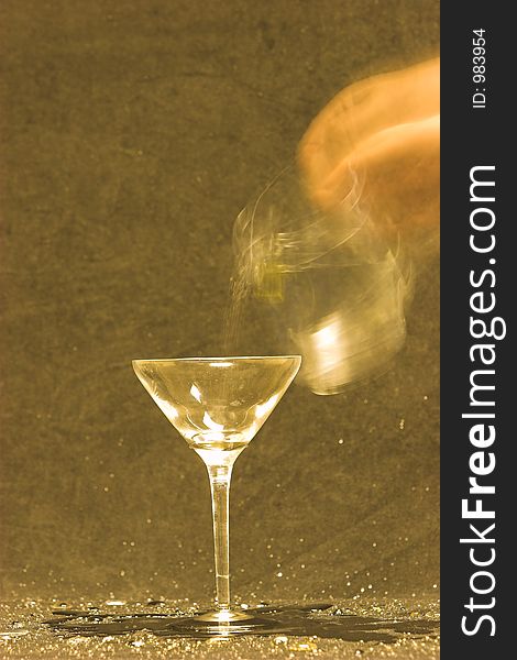 Blurred motion of throwing water into a martini glass. Blurred motion of throwing water into a martini glass