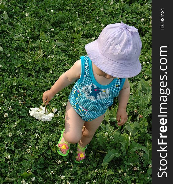 Little girl in lilac hat with white flower