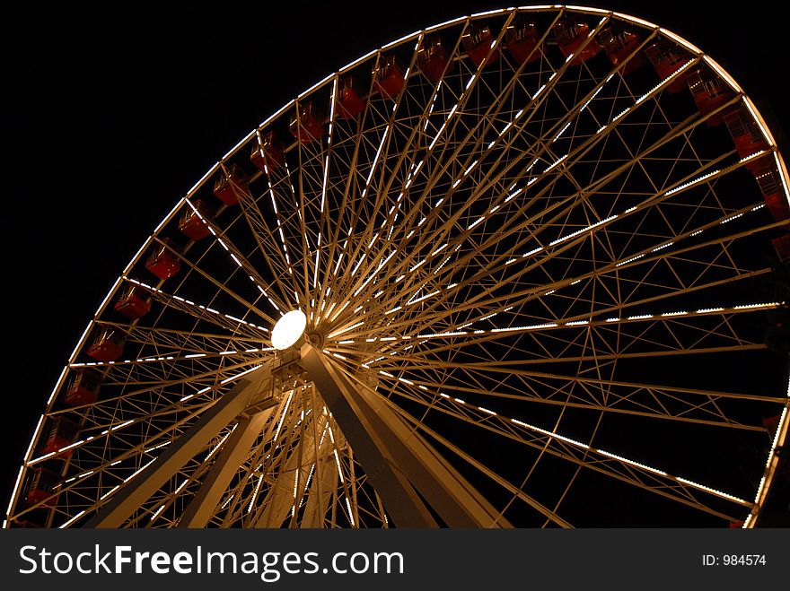 A glowing ferris wheel at night (on Chicago's Navy Pier)