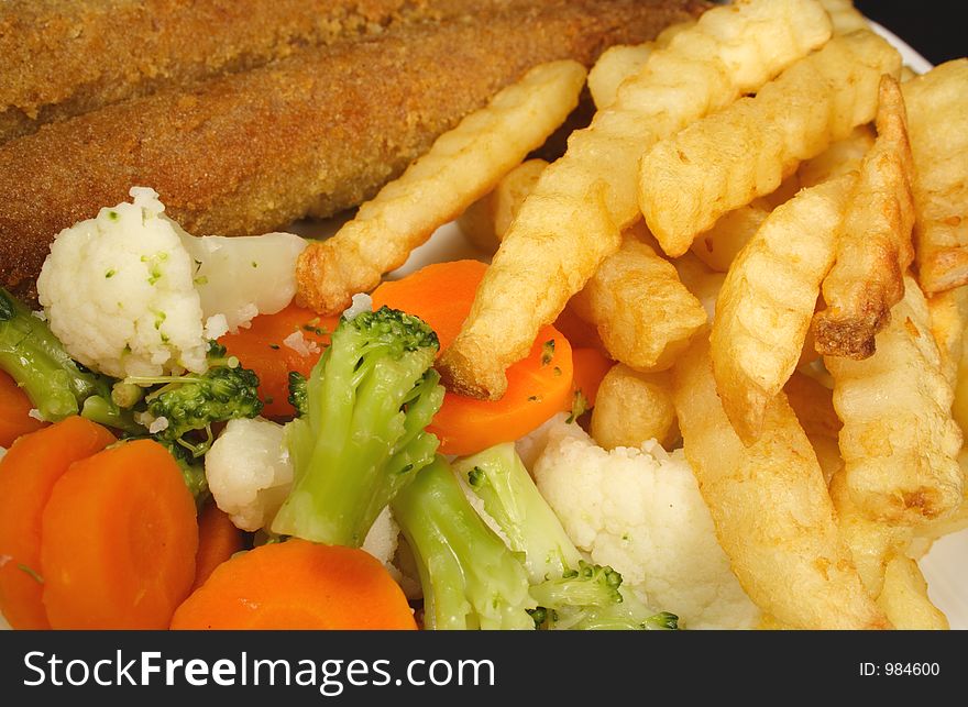 Crumbed sausages chips and vegetables. Crumbed sausages chips and vegetables