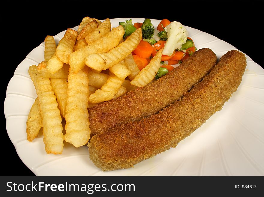 Crumbed sausages chips and vegetables. Crumbed sausages chips and vegetables