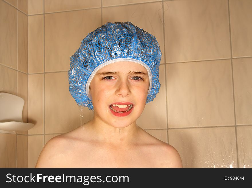 Cute boy wearing shower cap