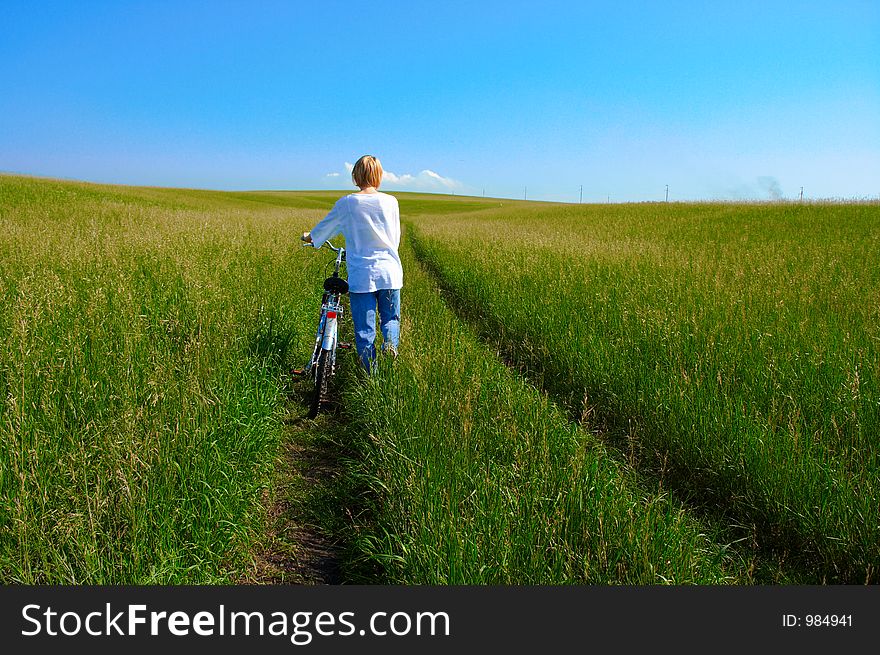 Beauty Girl And Bike In Field