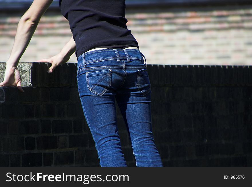 Young girl looking over the fence