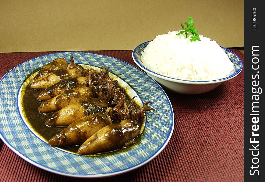 Squid on black sauce  whit boiled rice