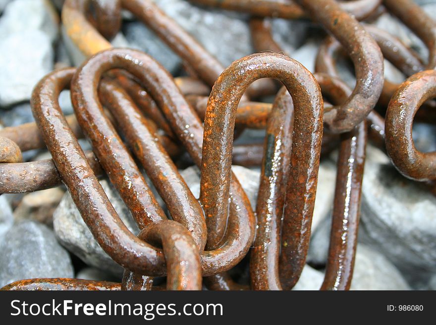 Rusted chain on stones
