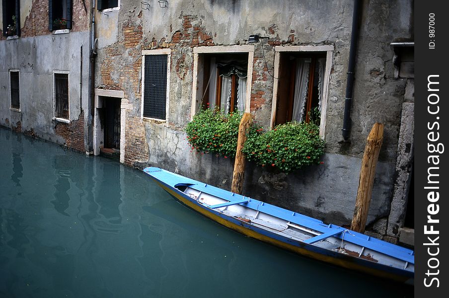 Gondola parked outside of someone's home in Venice, Italy.  Shot on medium-format slide film and scanned, for exquisite resolution at large print sizes. Gondola parked outside of someone's home in Venice, Italy.  Shot on medium-format slide film and scanned, for exquisite resolution at large print sizes.