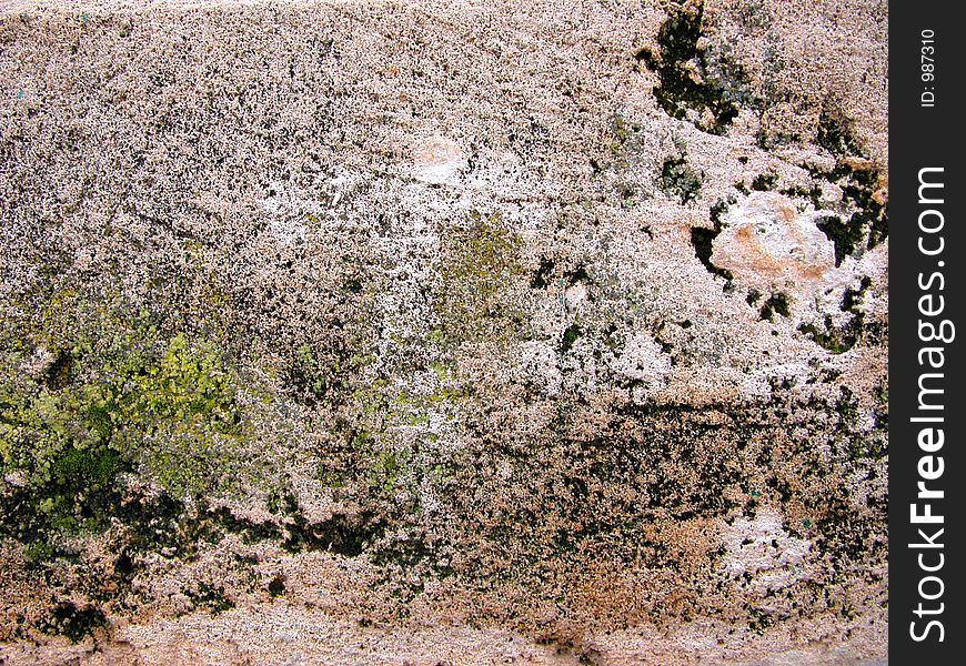 Eroded rock texture with some moss