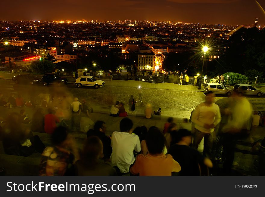 Late night in Paris - a view from stairs at Basilica Sacre Ceur, Monmartre, people admiring view, long exposition,. Late night in Paris - a view from stairs at Basilica Sacre Ceur, Monmartre, people admiring view, long exposition,