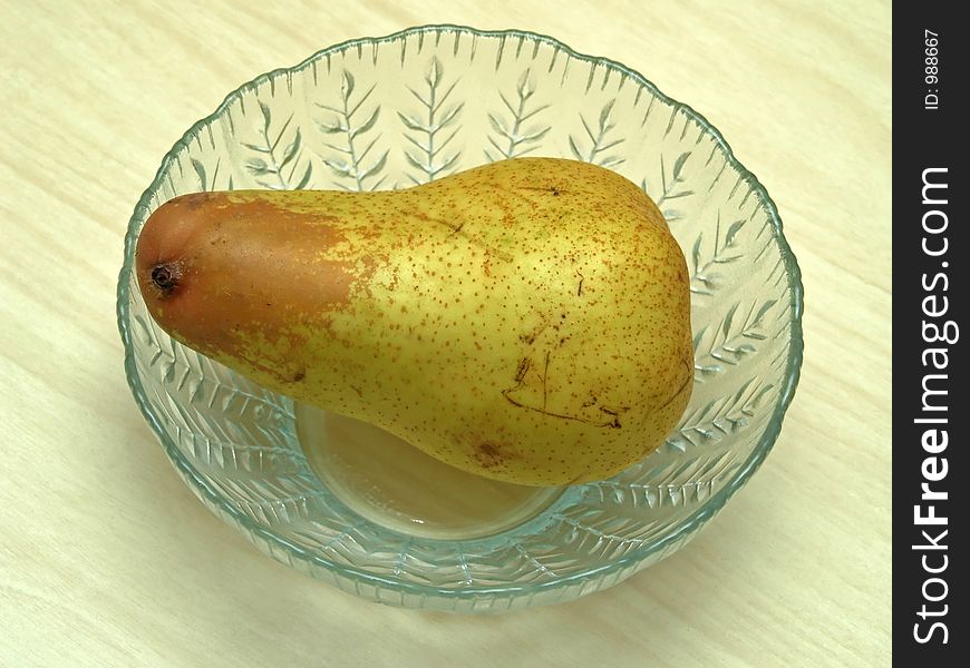 Pear in a glass dish. Pear in a glass dish