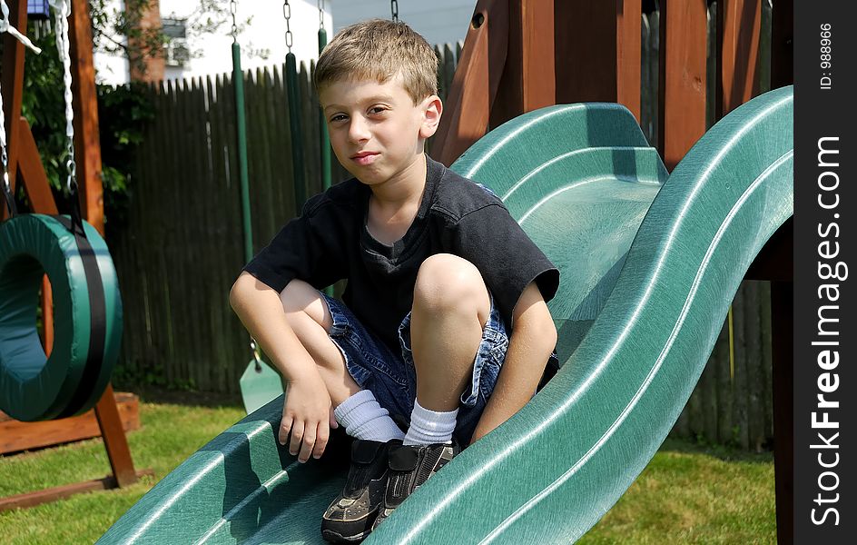 Young Boy on a Slide. Young Boy on a Slide