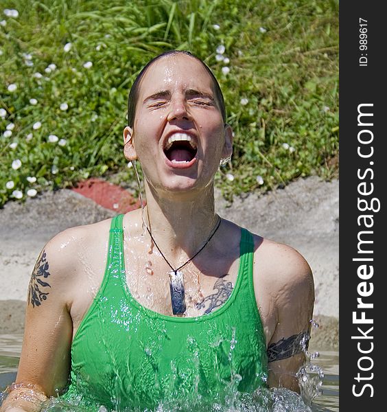 Woman exiting water in a splash. Woman exiting water in a splash