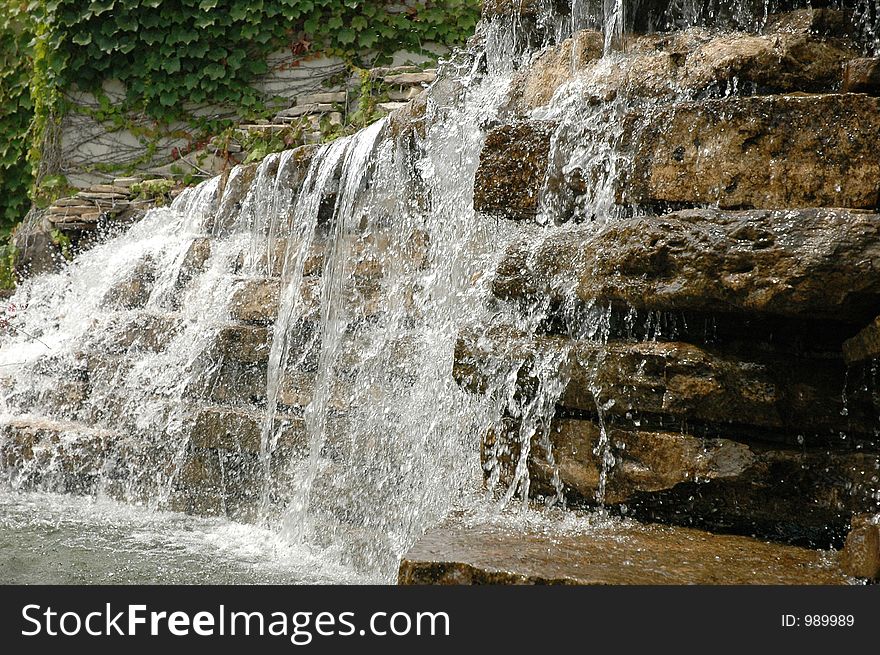 Waterfall frozen in motion cascading over tack sharp rocks.