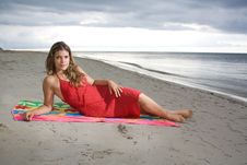 Attractive Girl Laying On A Towel With Red Dress Stock Photos Attractive Girl Laying On A Towel With Red Dress Stock Photos
