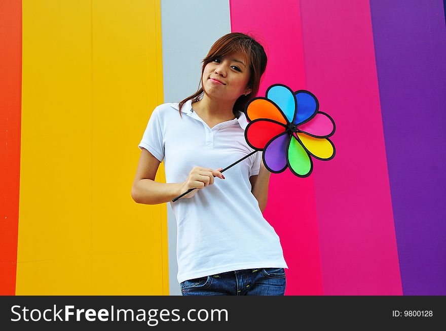 Smiling beautiful young Asian woman with colourful background. Smiling beautiful young Asian woman with colourful background.