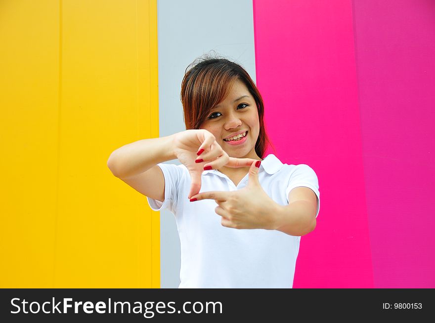 Smiling beautiful young Asian woman with colourful background. Smiling beautiful young Asian woman with colourful background.