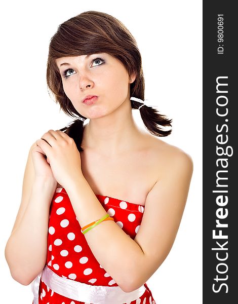 Young pretty girl in dot polka dress on white background