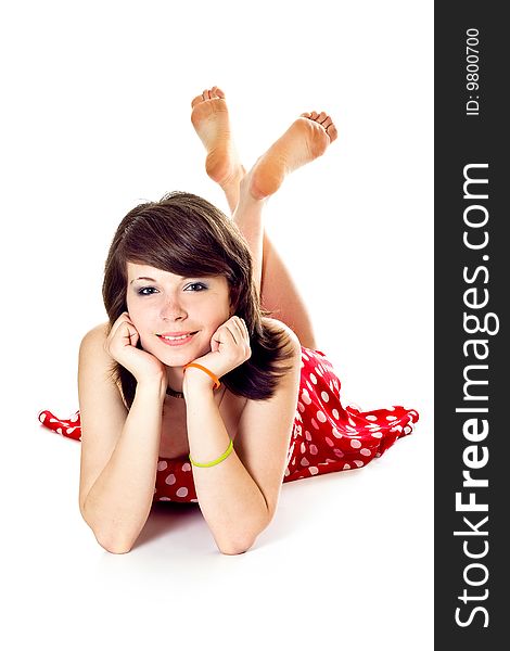 Young pretty girl in dot polka dress on white background