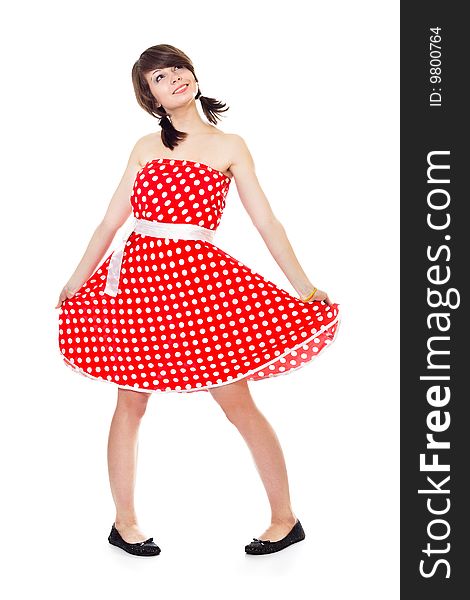 Young pretty girl in dot polka dress on white background