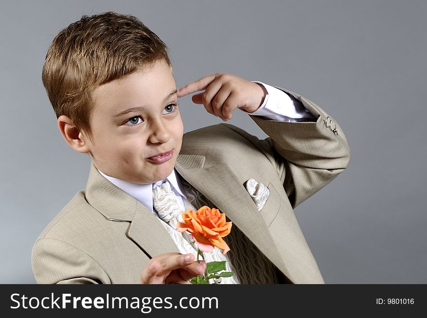 Close up with little boy preparing to offer a flower. Close up with little boy preparing to offer a flower