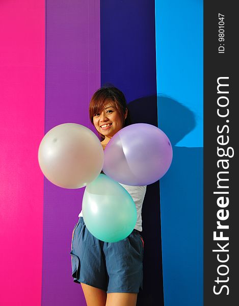 Young Asian Woman Holding Balloons