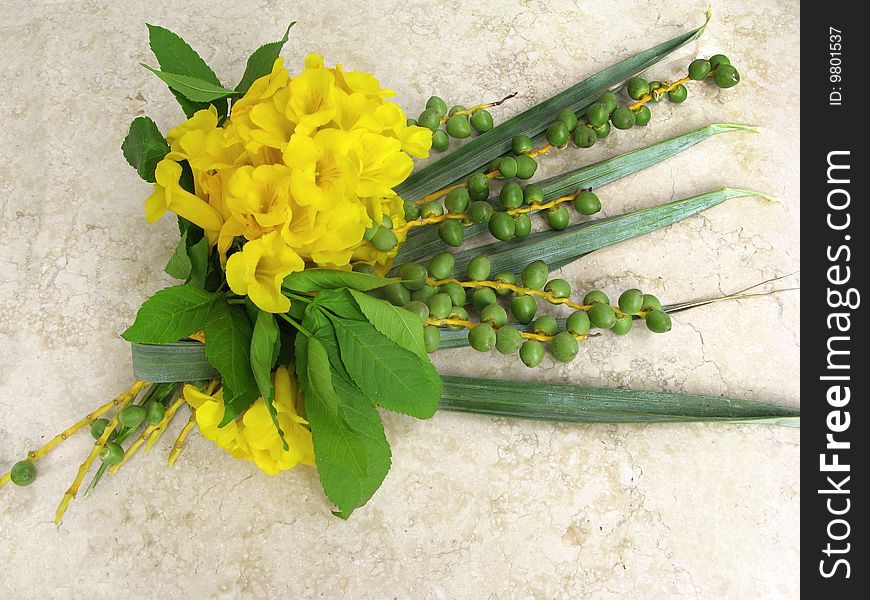 Bouquet from leaves of palm and acacia on marble background. Bouquet from leaves of palm and acacia on marble background