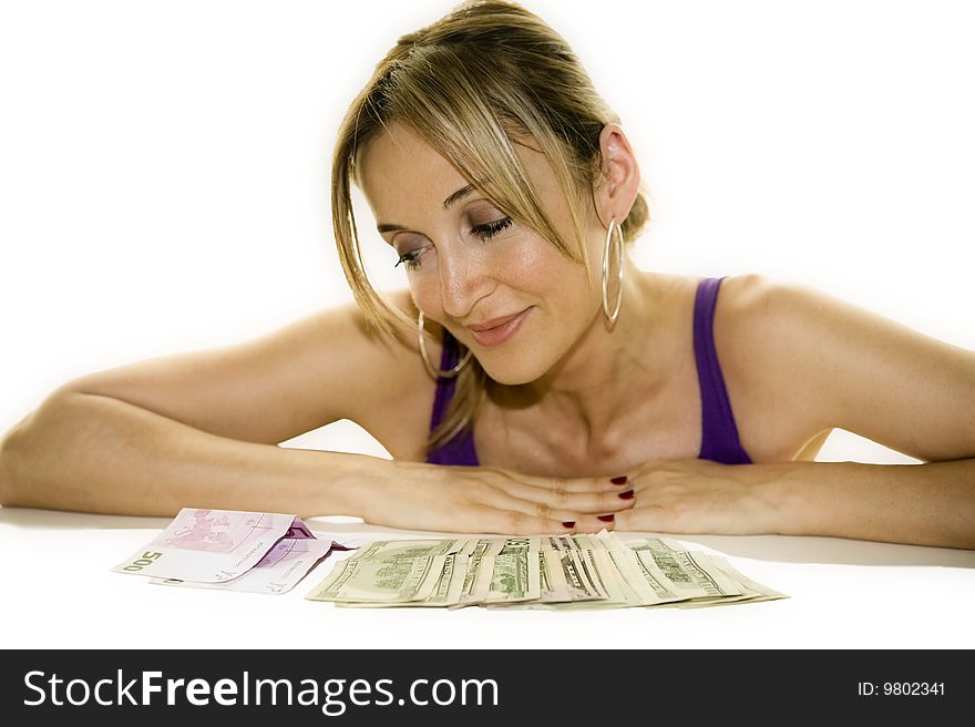 Woman leaning on a table looking at some cash. Woman leaning on a table looking at some cash