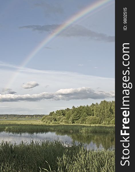 Rainbow over the lake landscape. Rainbow over the lake landscape