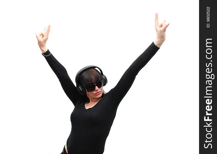 Woman in black clothes, black glasses and headphones on a white background. Woman in black clothes, black glasses and headphones on a white background