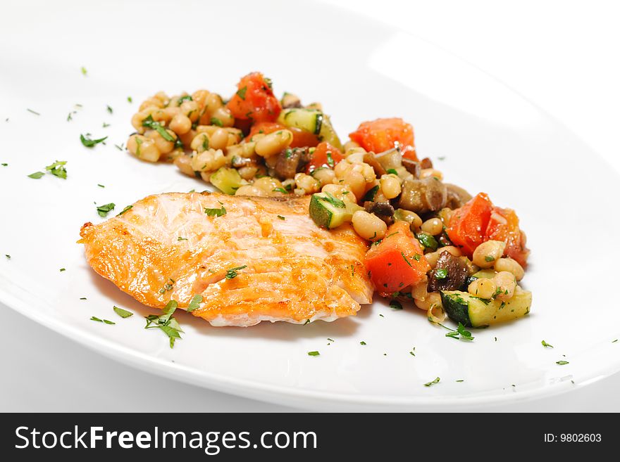Salmon with Fried Vegetables. Isolated on White Background. Salmon with Fried Vegetables. Isolated on White Background