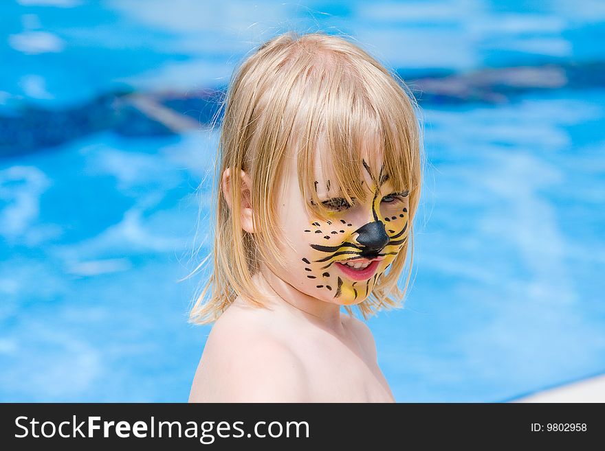 Girl with paint on his face in the pool. Girl with paint on his face in the pool