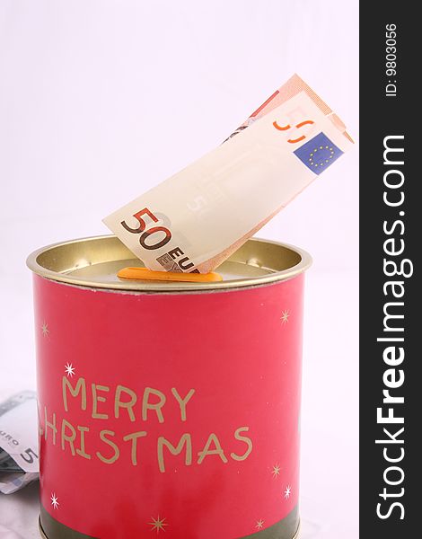 Christmas savings, euro bills and coins with velvet decorations