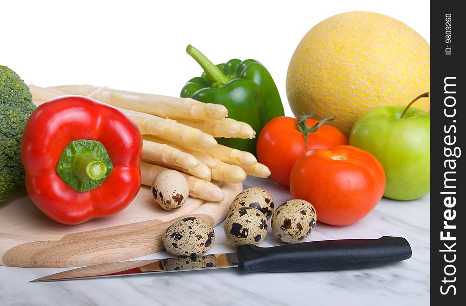 Fresh vegetables (quail eggs,melone,knife, tomato, paprika, asparagus)