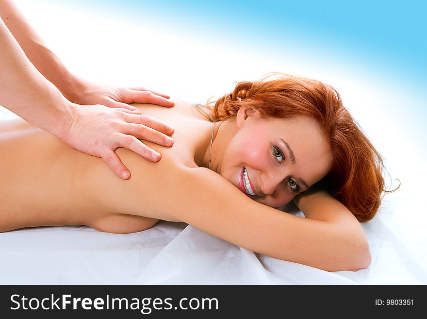 Man hand massage beauty redheaded girl