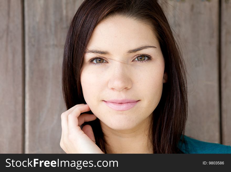 A Beautiful Brunette with fresh skin looking at camera