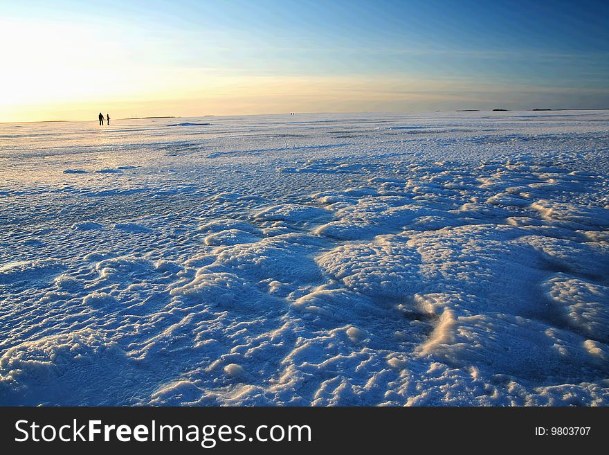 Sunset over frozen lake in winter, Finland
