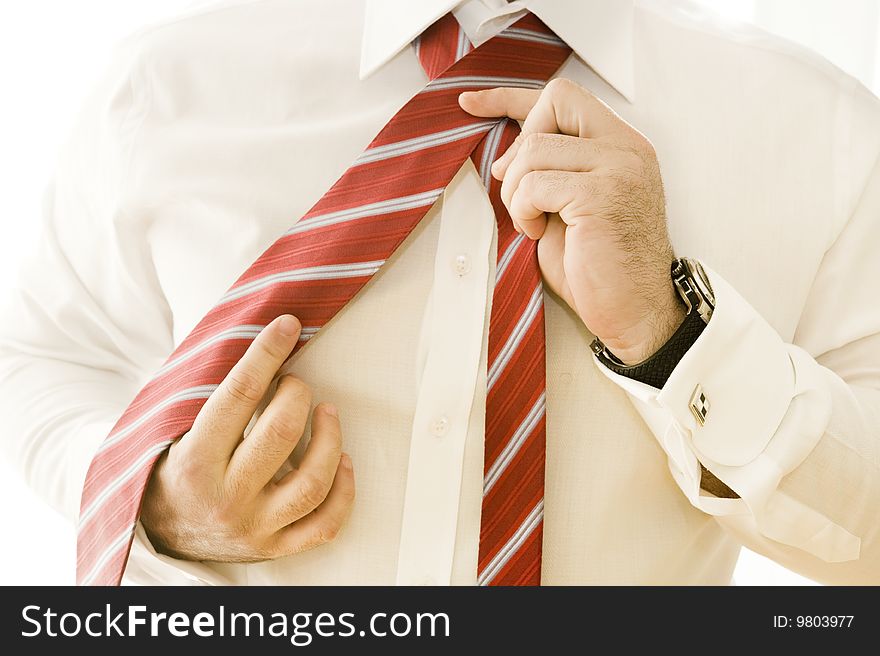 Businessman adjusting tie