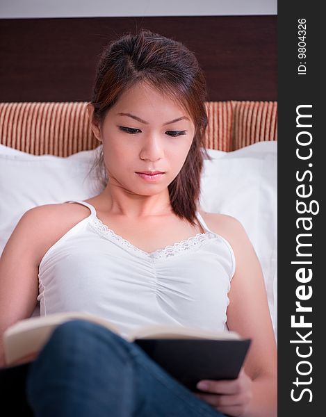 An image of an asian female student studying. An image of an asian female student studying