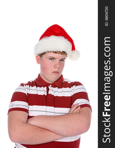 Teenage boy in santa hat with arms crossed. Teenage boy in santa hat with arms crossed