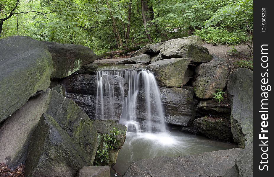 Central Park, New York City waterfall in Northwoods on a rainy day in June