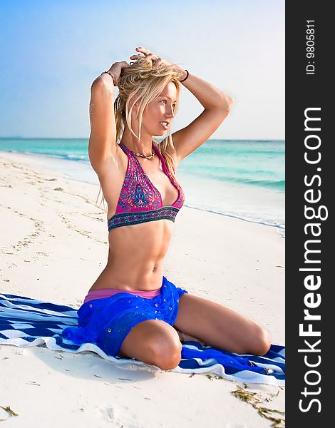 Beautiful blondy relaxing on tropical beach